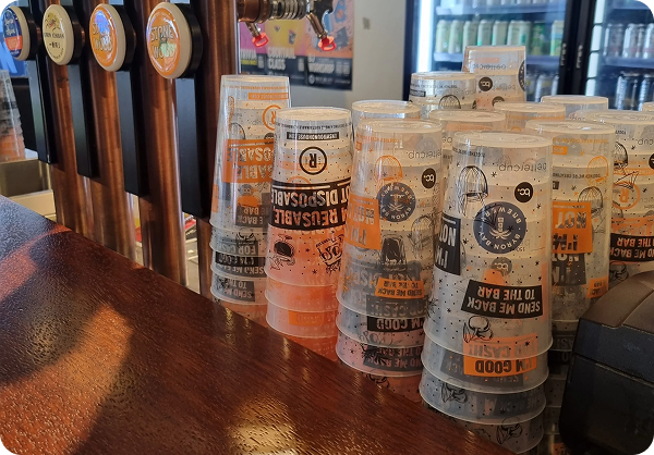 Venues use reusable cups to save money and cut on waste, with stacks of bettercup reusable tumbler cups sitting on a bar at a live music venue.