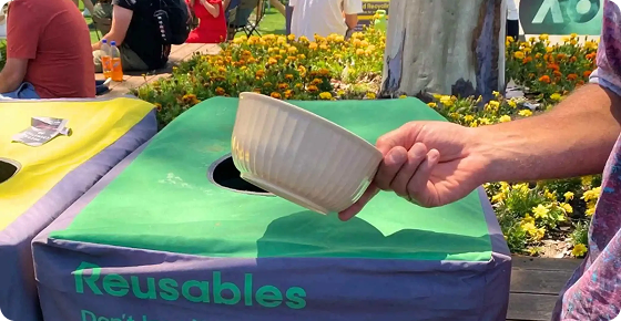 Patron returning a Green My Plate reusable food bowl at the Australian Open reusable return station