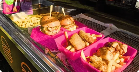Line of pink betterdish loaded with burger and fries at Moomba Festival 2026