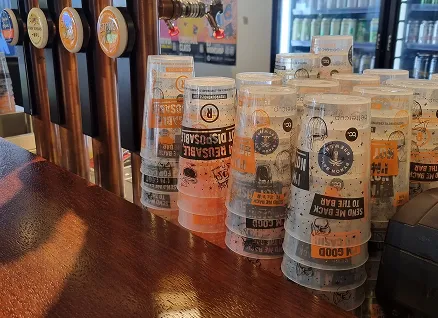 Venues use reusable cups to save money and cut on waste, with stacks of bettercup reusable tumbler cups sitting on a bar at a live music venue.