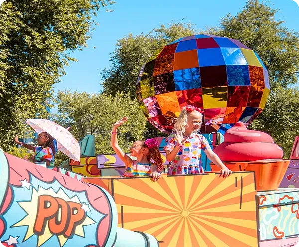 Children on top of a colourful carnival-style floatie with pop art decorations and a large mirrored disco ball sculpture at Moomba Festival 2026
