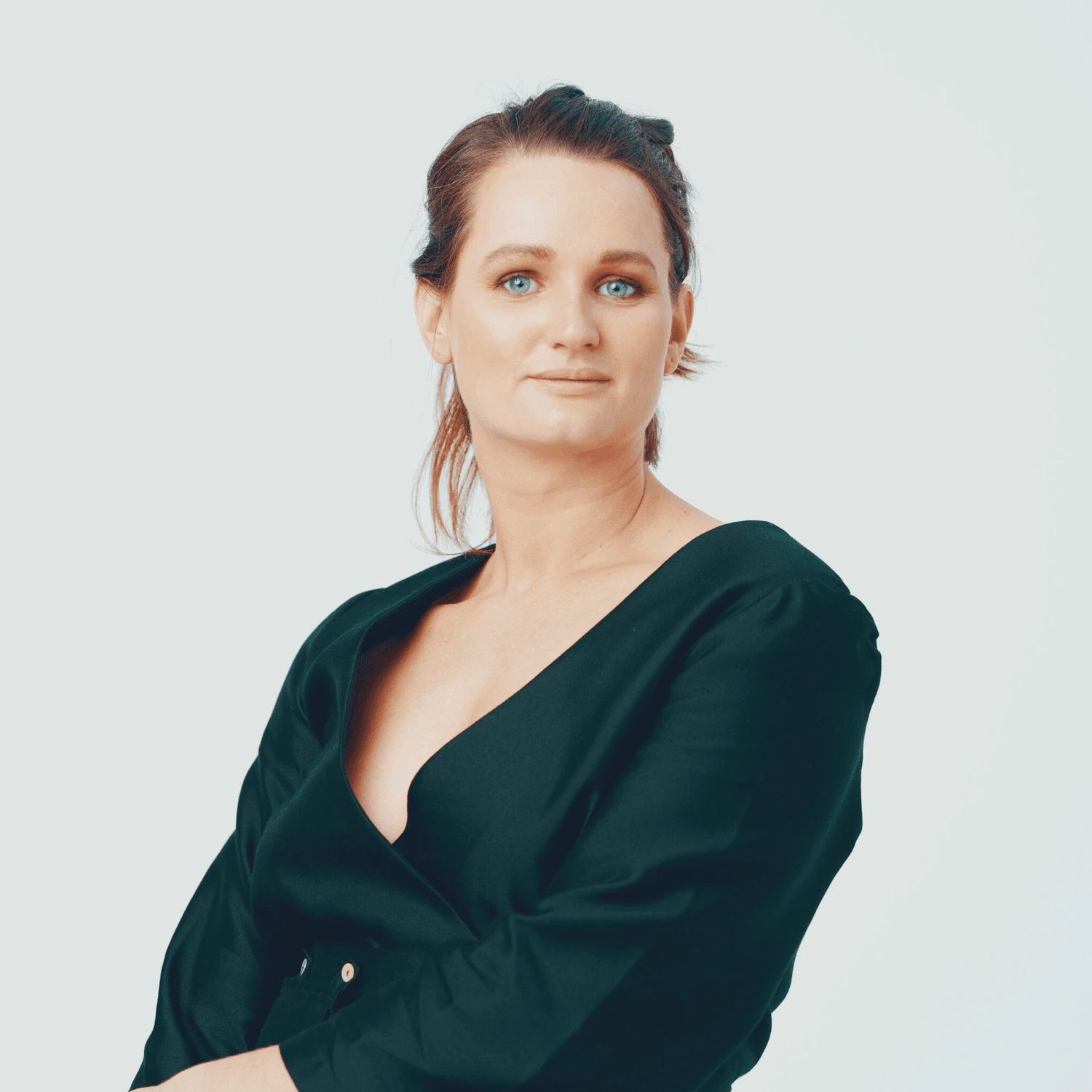 Photo of Samantha Stone, co-founder of bettercup. She is a woman with brown hair and blue eyes wearing a black blouse, looking slightly to the side with a serious expression.